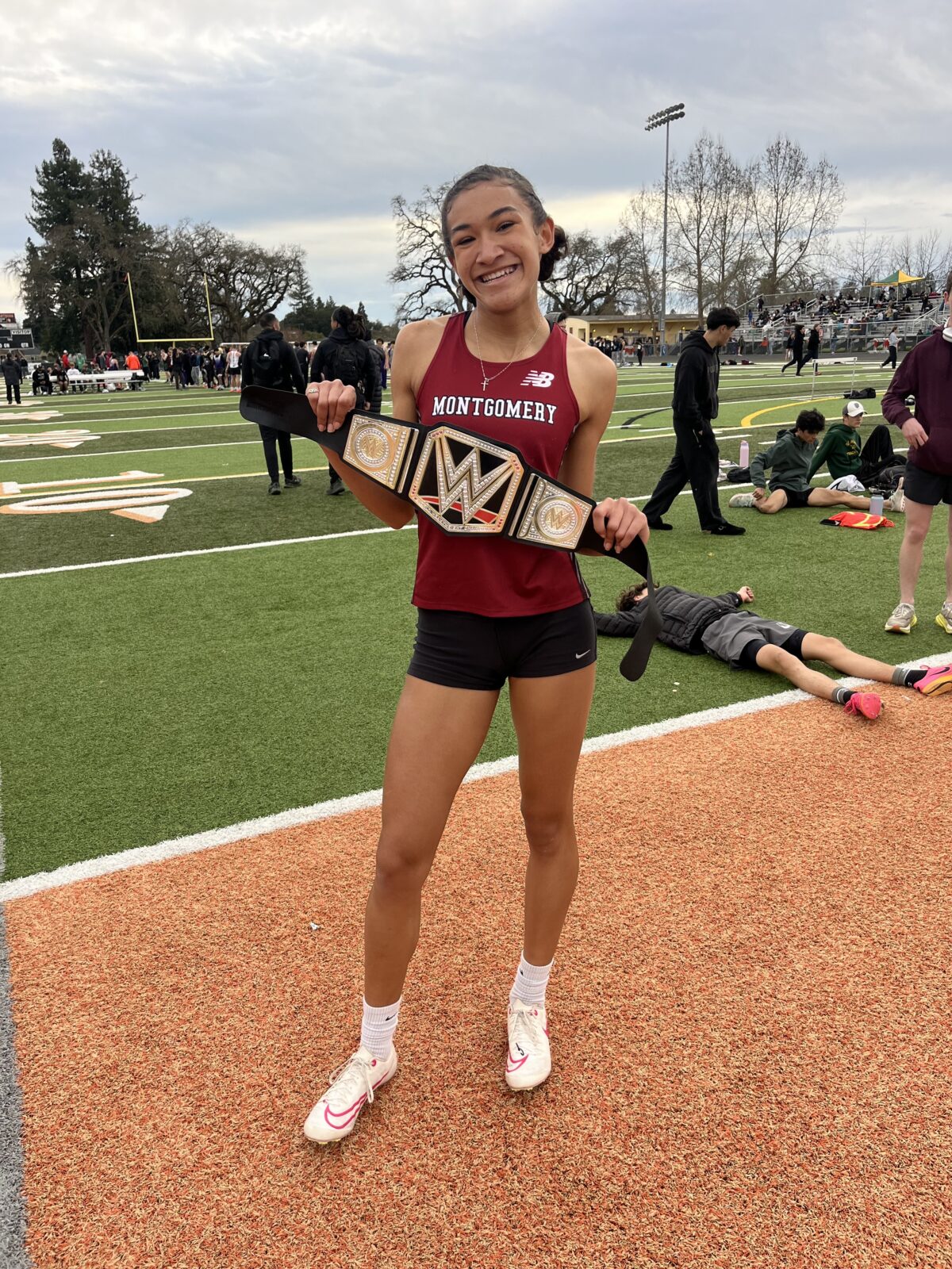 Montgomery runner posing with championship-style belt