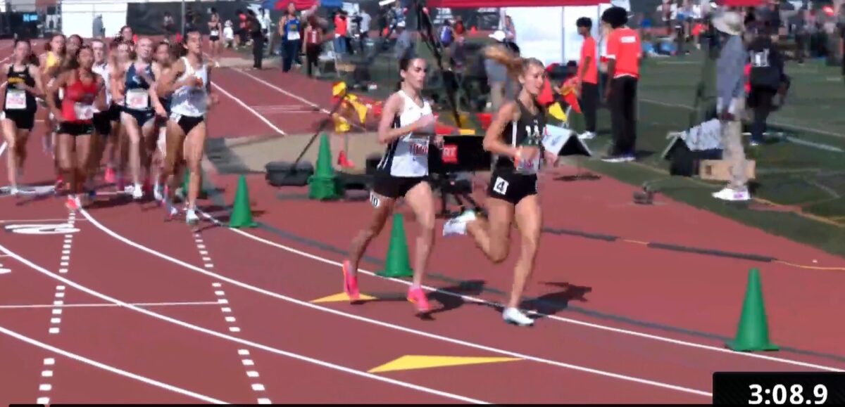 Two lead runners rounding sunny track curve