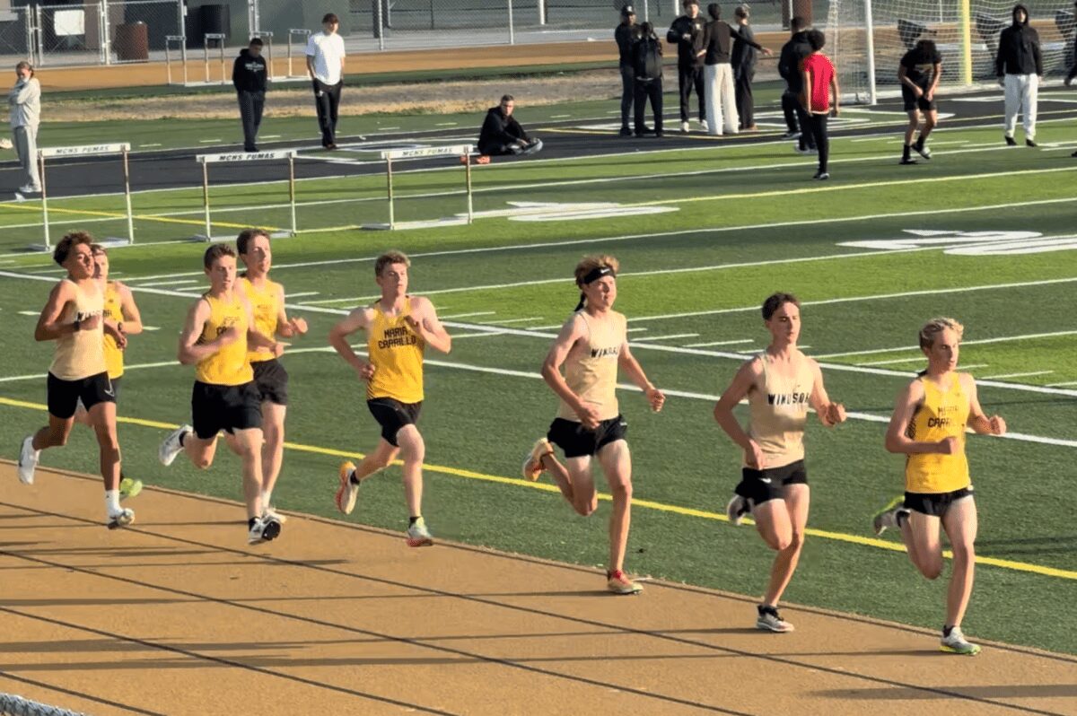 Pack of teenage athletes circling school track