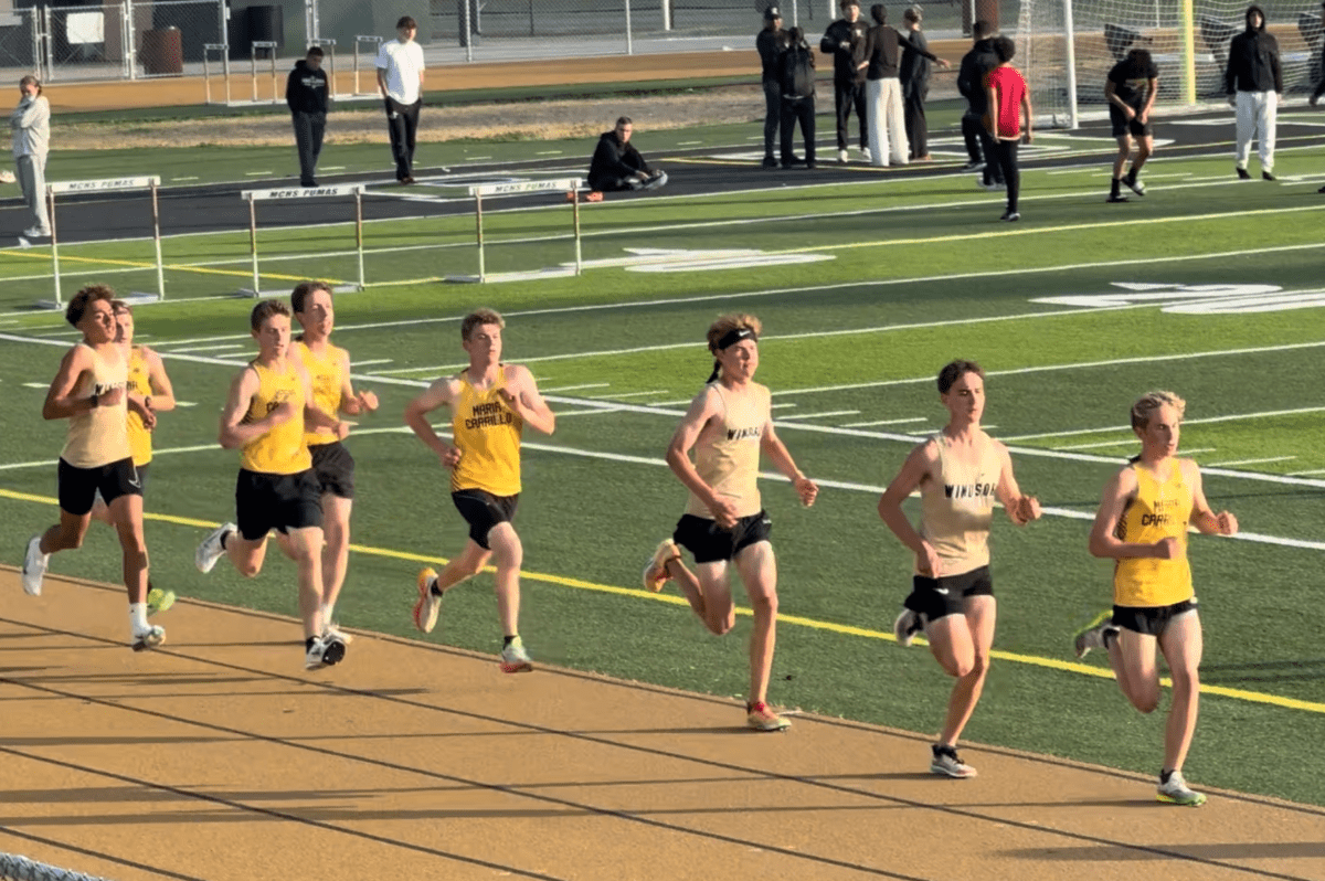 Pack of teenage athletes circling school track