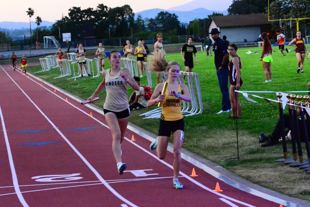 Baton runner checking watch near finish