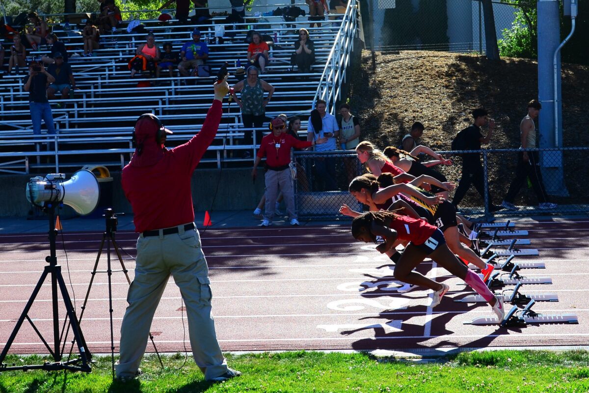 Starter firing pistol as racers explode forward