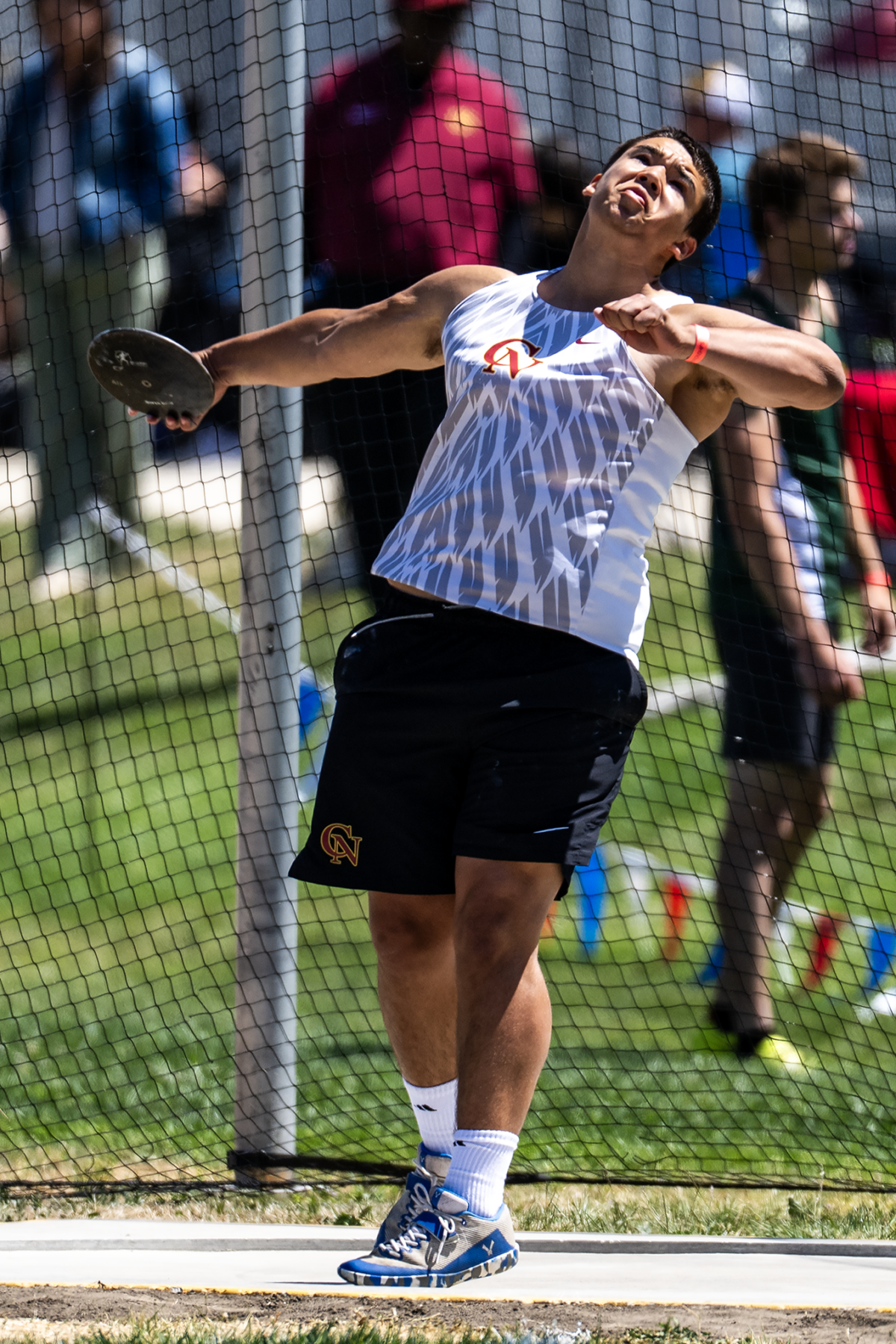 Athlete's arm extended, disc about to fly