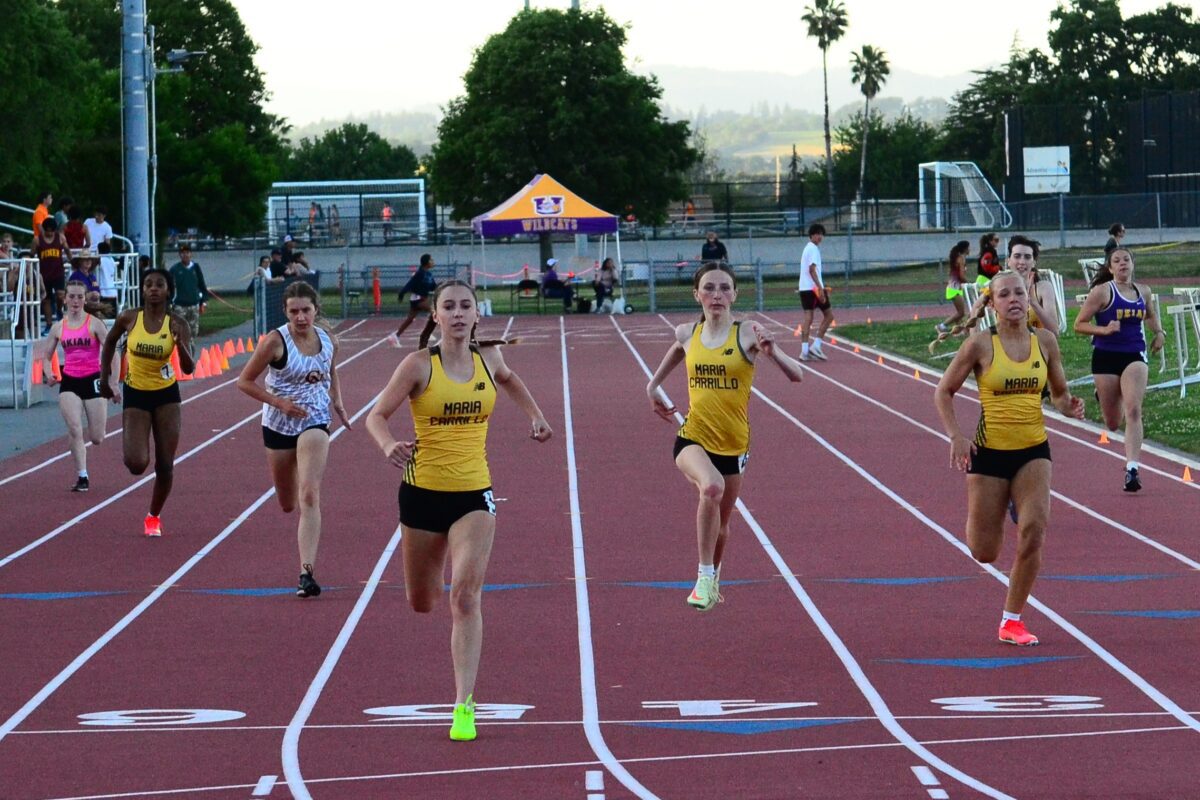 Green and pink spikes flash as runners finish