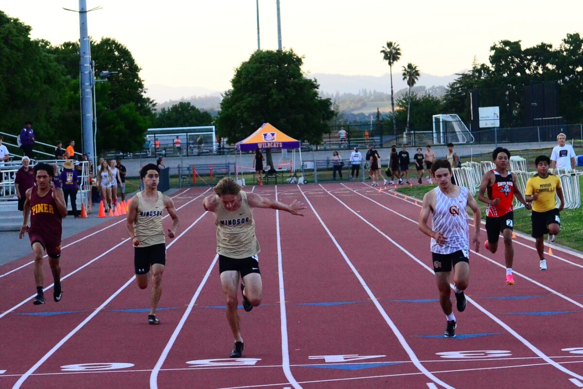Runners converging near finish on red track