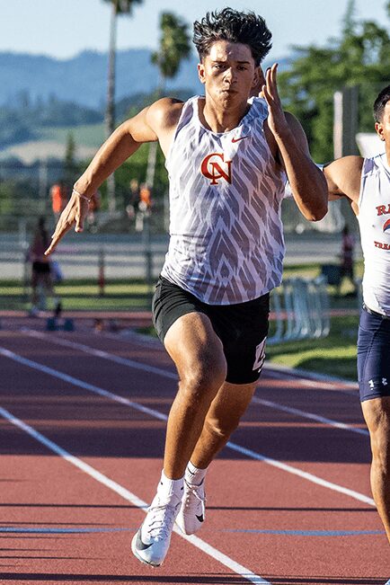 Explosive stride by sprinter on red track