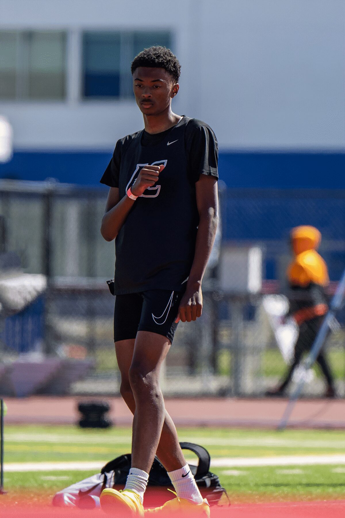 Male track athlete standing on track