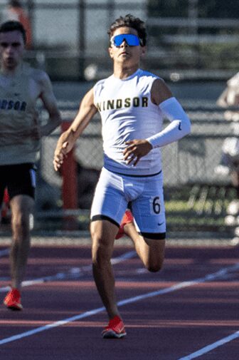 Sprinter in Windsor uniform racing on outdoor track