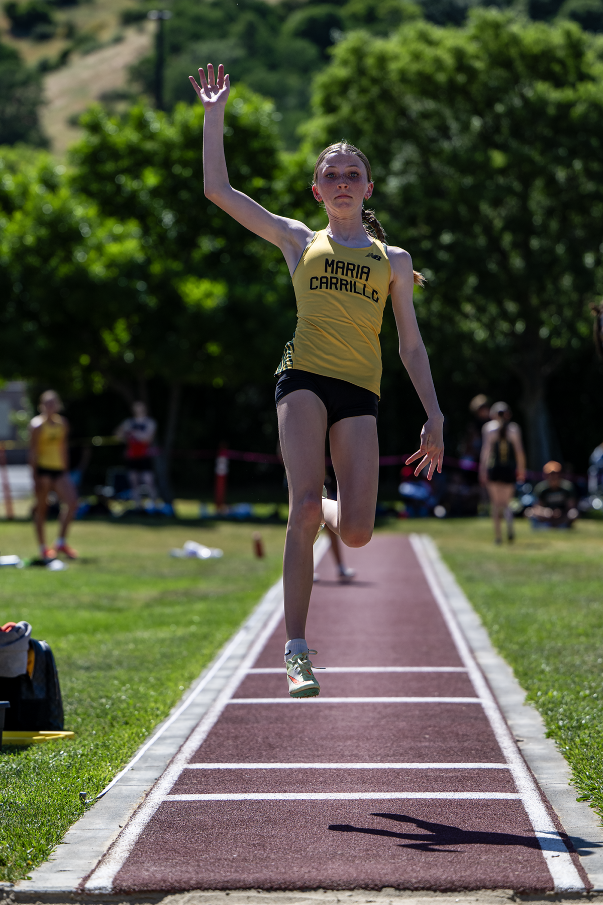 Female athlete mid-air during long jump