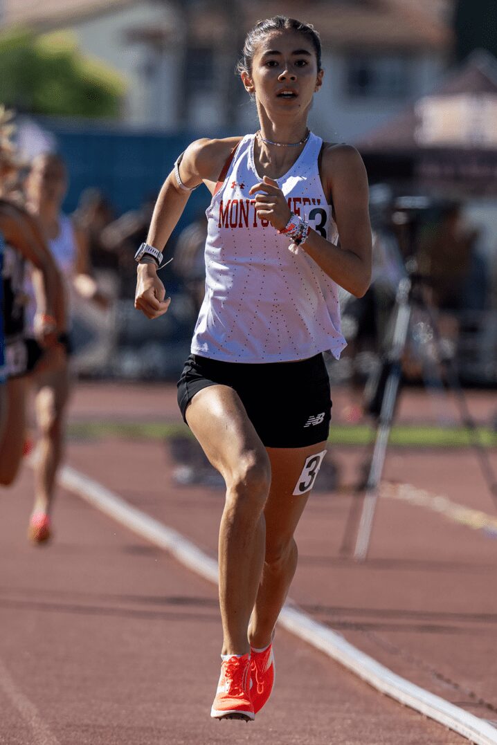 Runner wearing layered bracelets dashes forward