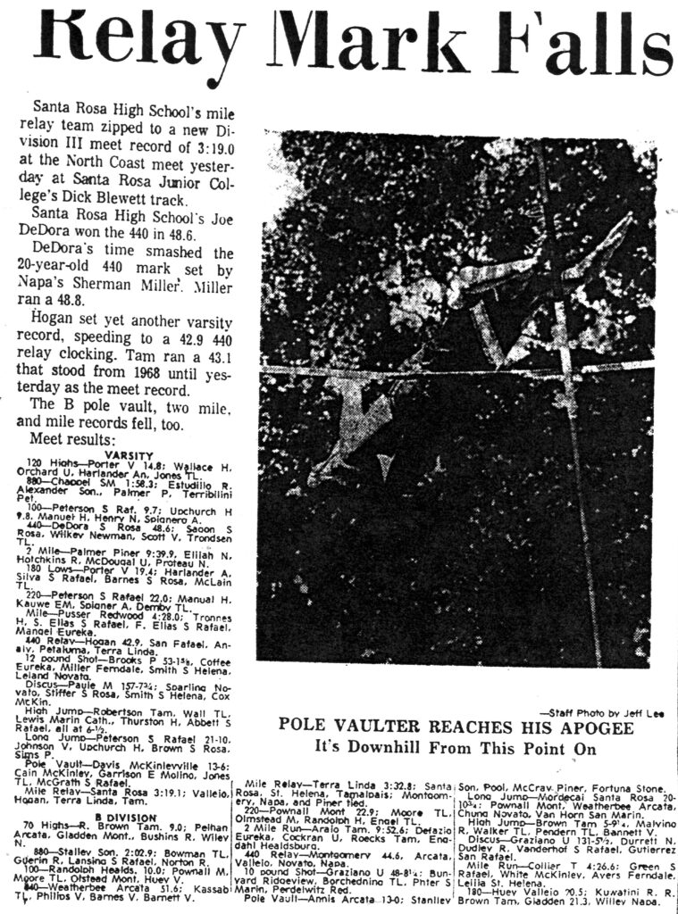 Pole vaulting athlete clears the bar during a track meet in this vintage photo.