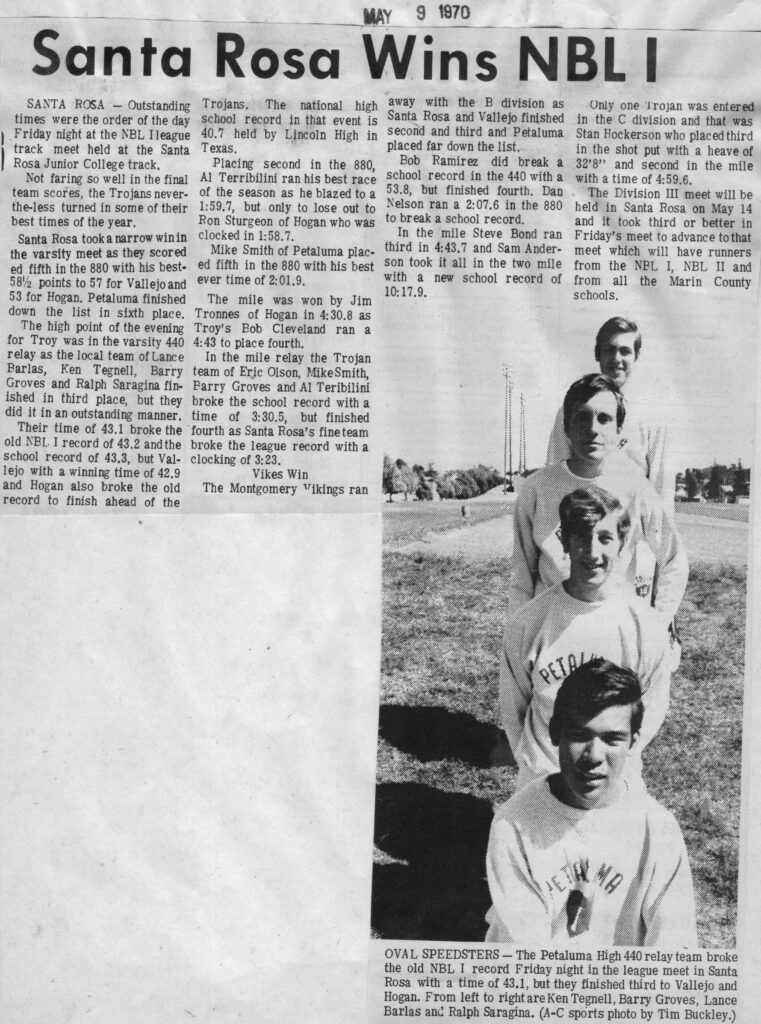 A group of five men standing in a line outdoors with a newspaper article above.