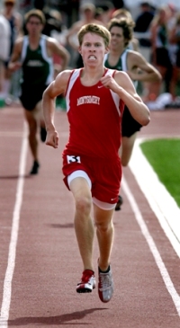Athlete sprinting on a track during a race.