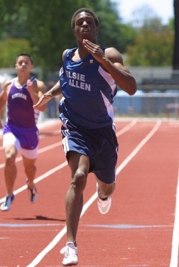 Two athletes sprinting on a track during a race.