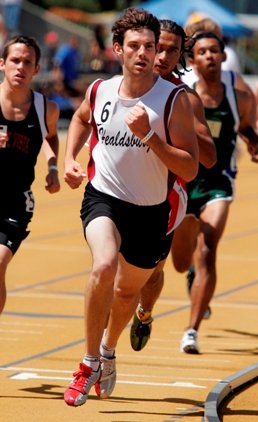 Athletes sprinting intensely on a track during a race.