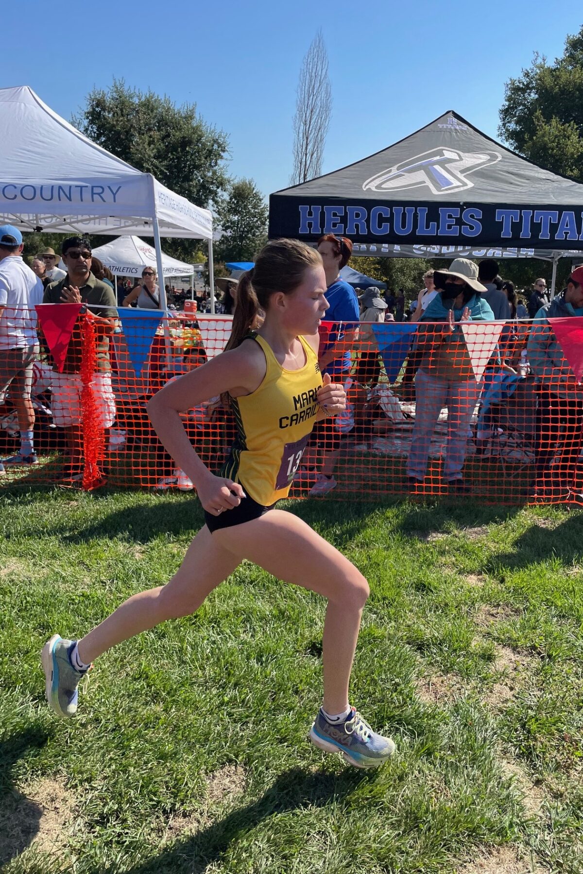 Young athlete sprinting during an outdoor race event.