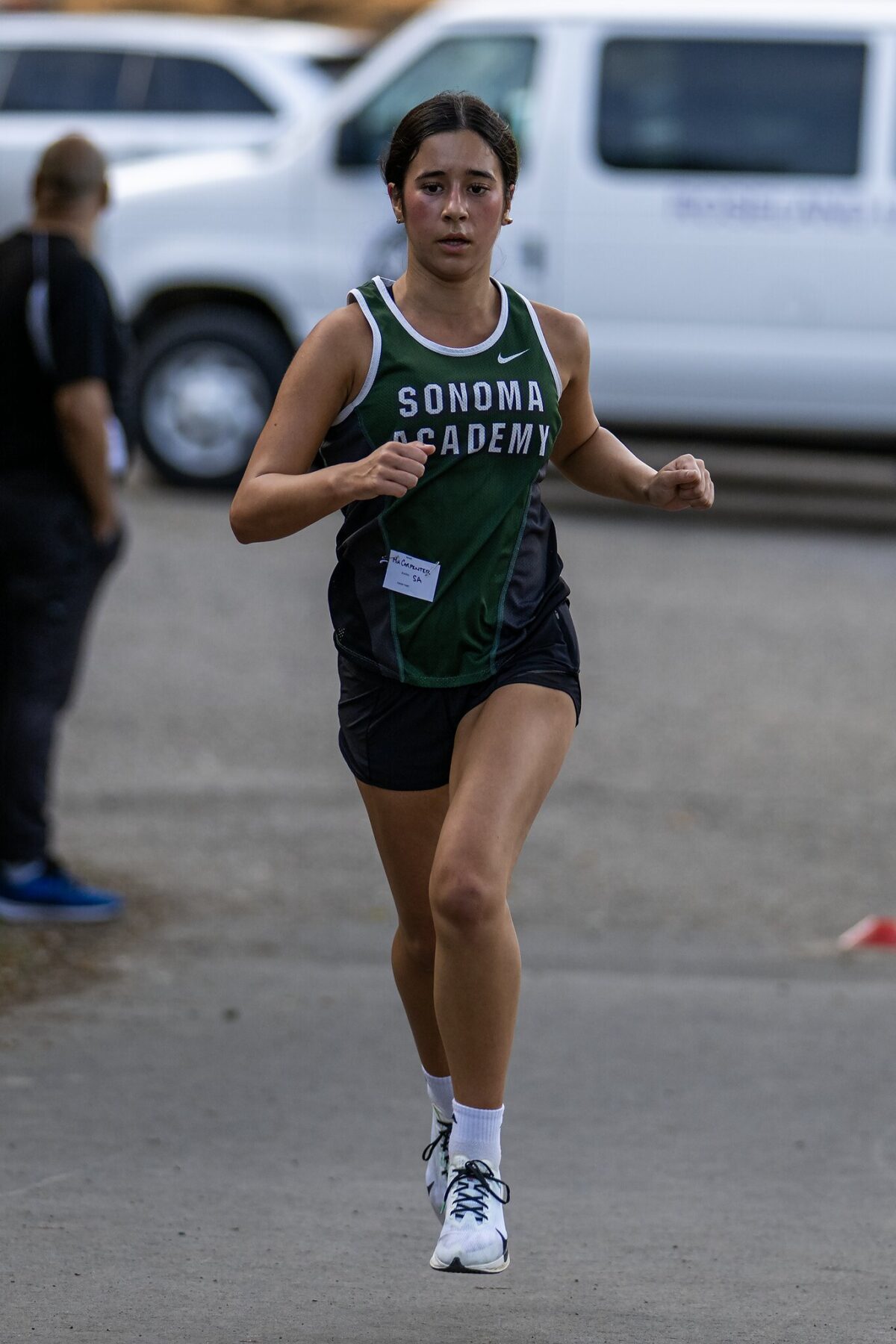 Female cross-country runner in Sonoma Academy jersey