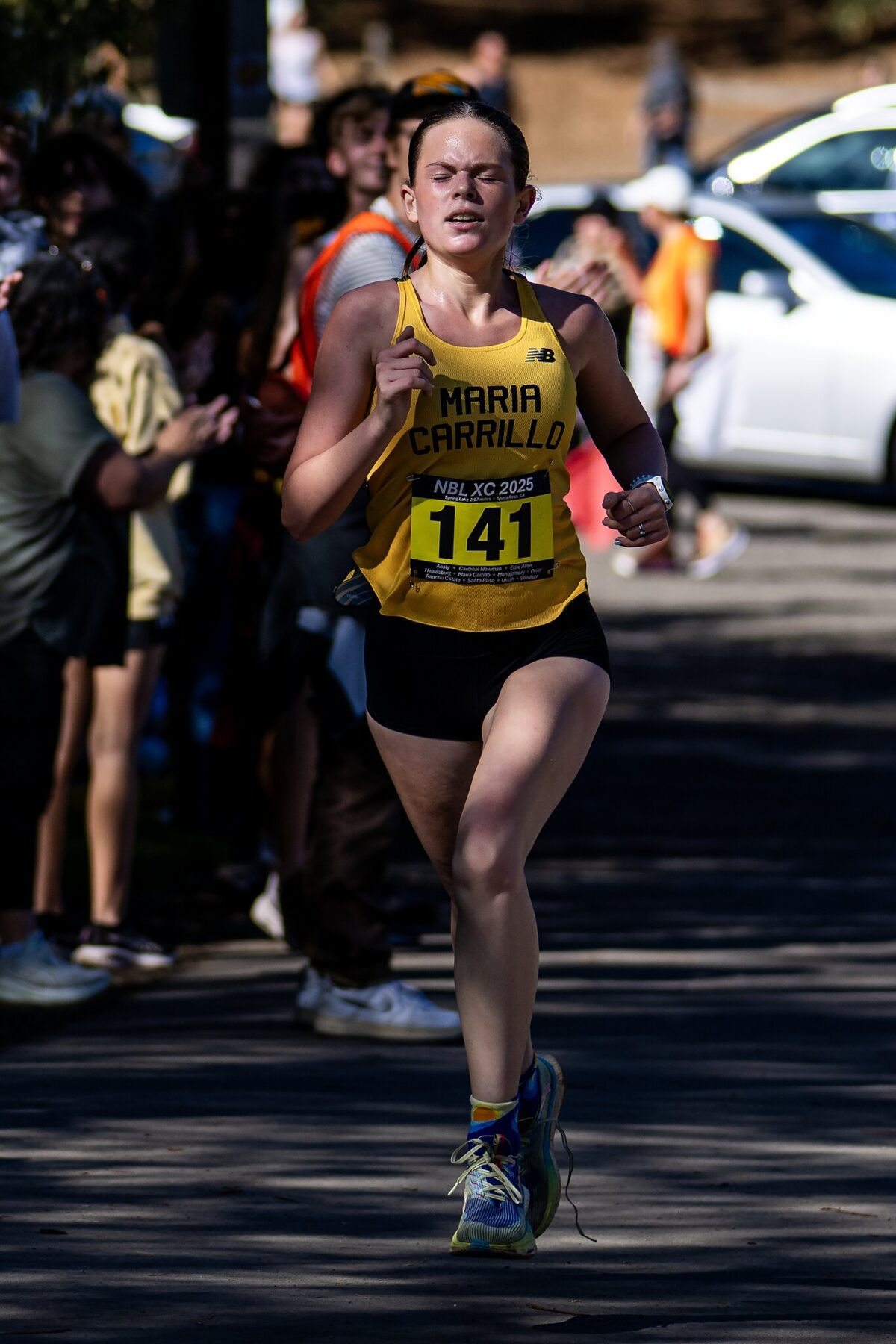 Runner in yellow singlet racing on road