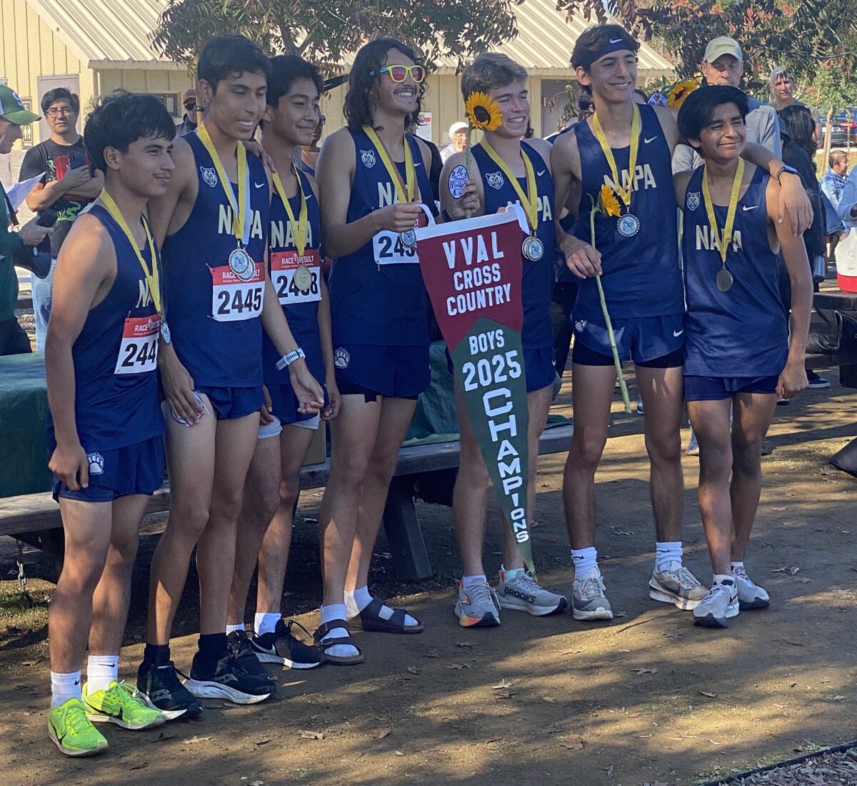 High school cross-country team with championship pennant
