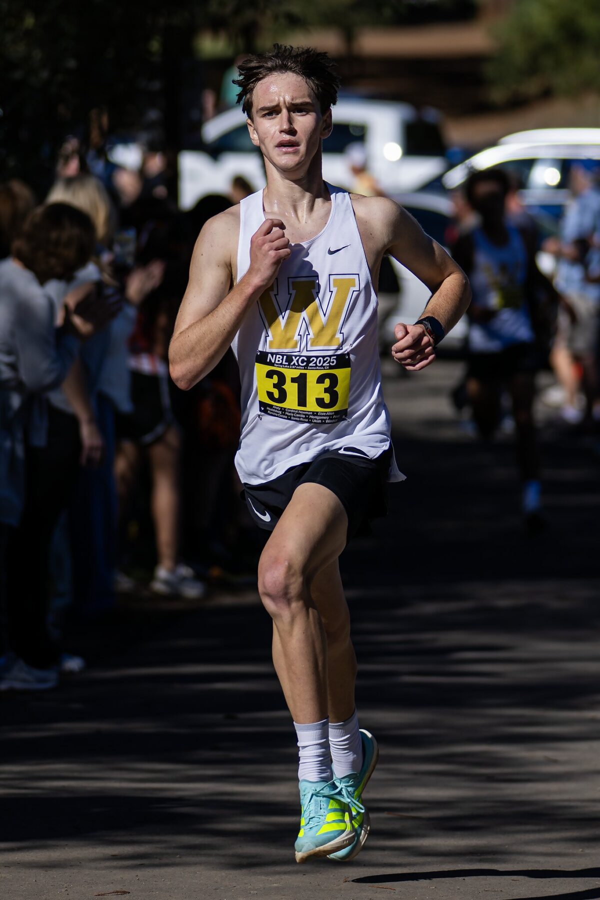 Young runner in white singlet with bib 313