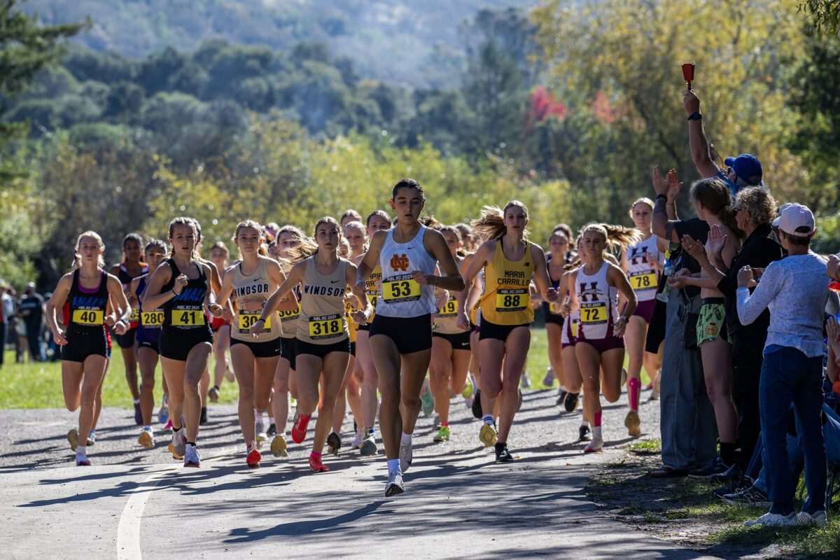 Runners surging from start with spectators cheering
