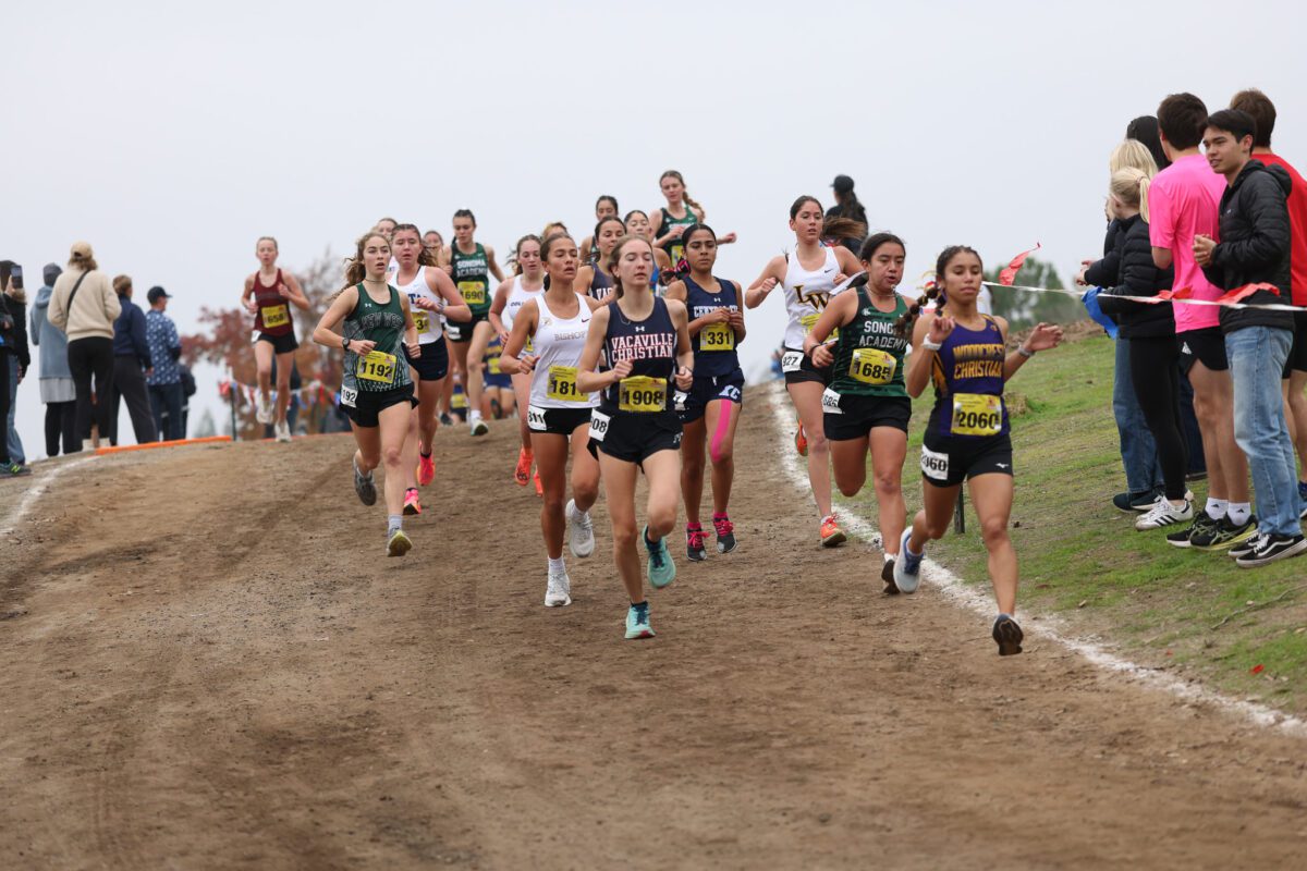 Large pack rounding a muddy uphill turn