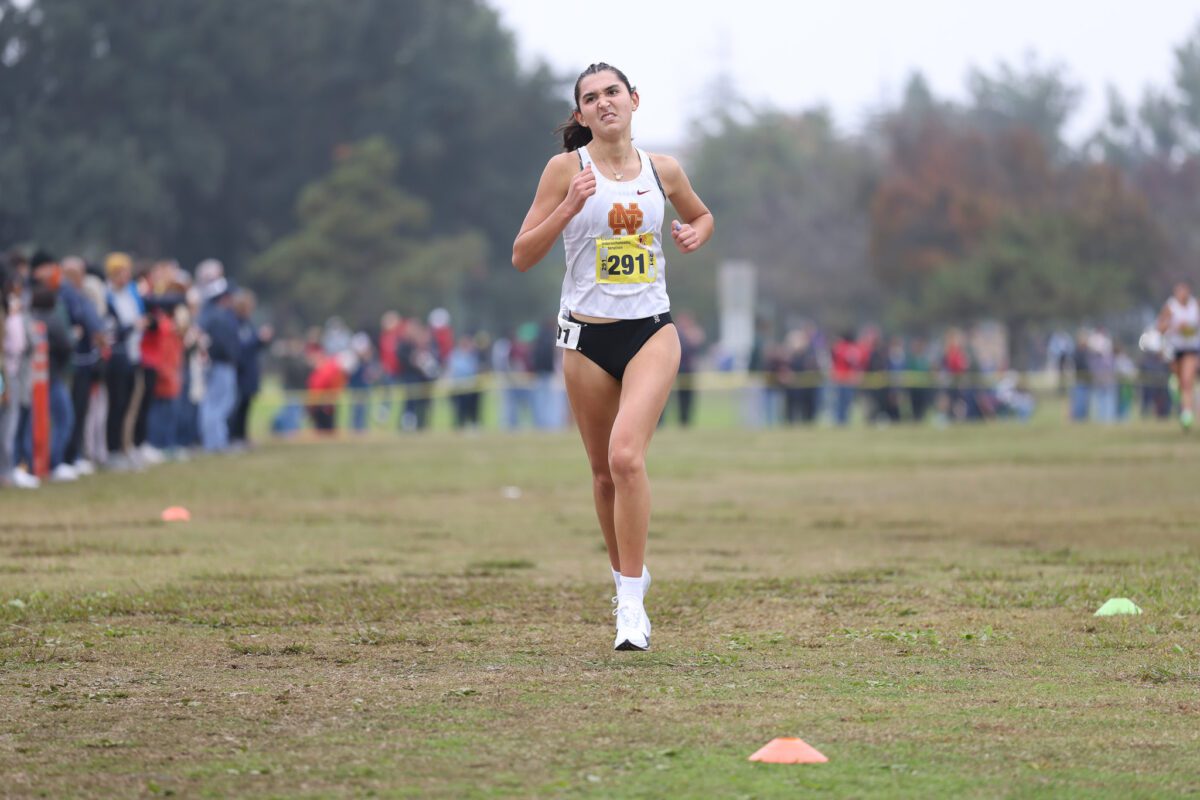 Female cross-country runner racing outdoors