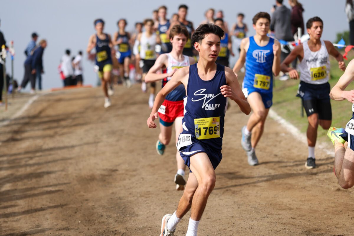 Cross-country runners racing on a dirt path