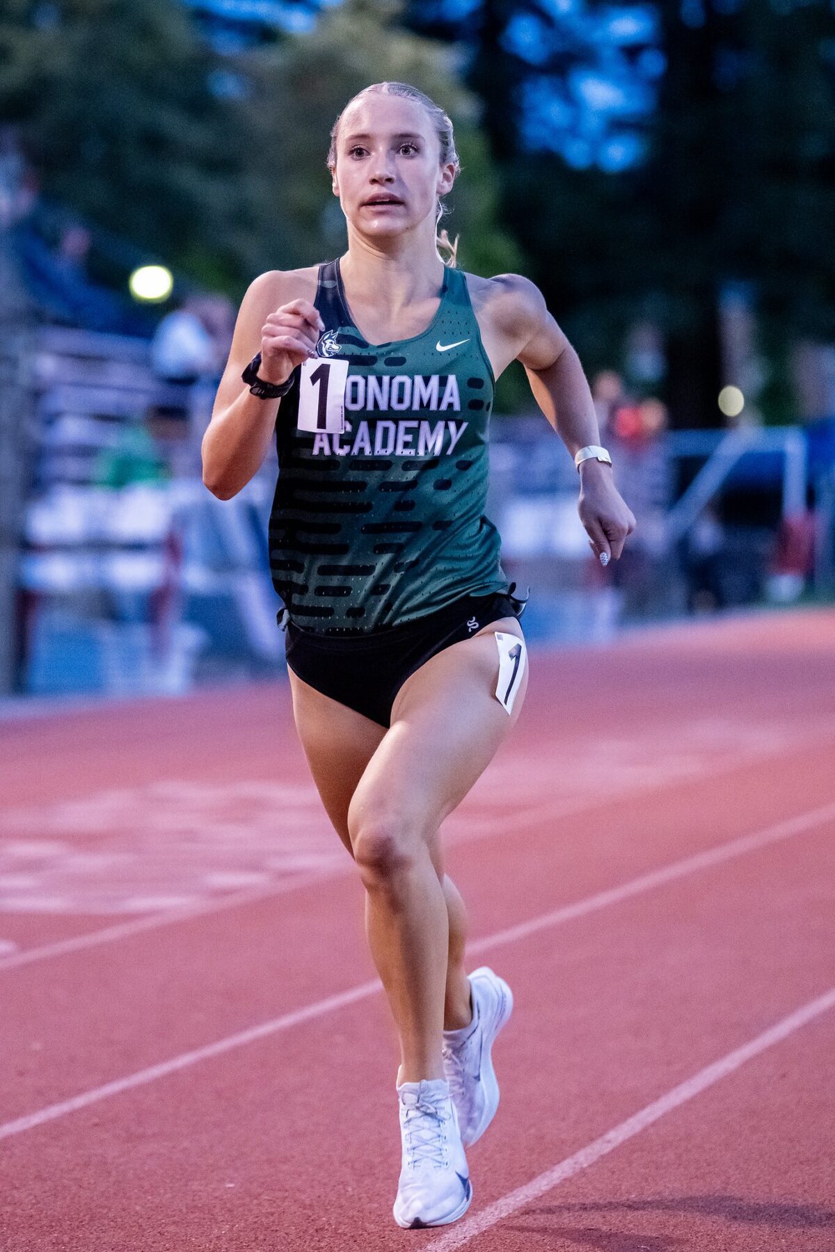 Runner in green Sonoma Academy uniform sprinting