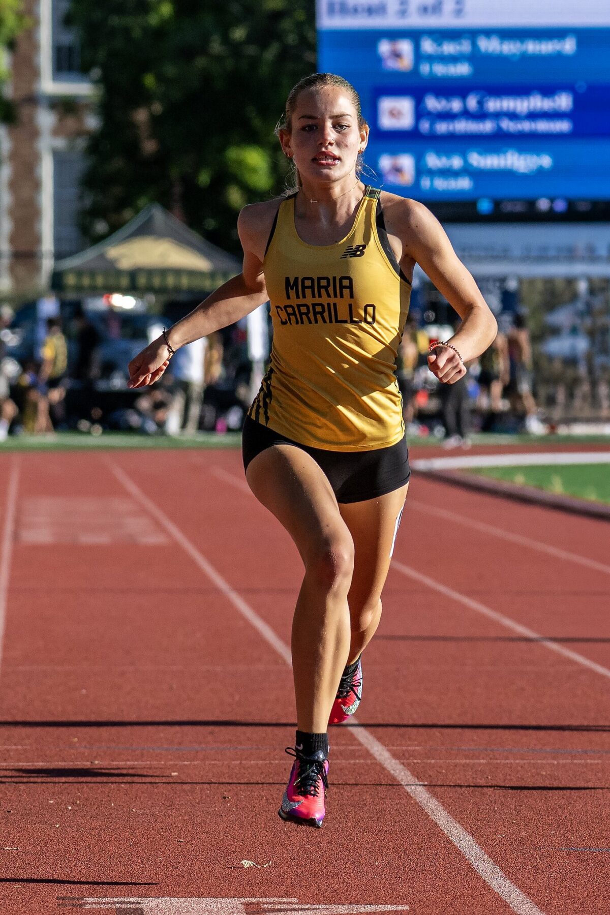 Female sprinter running in competition on track